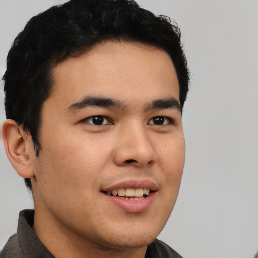 Joyful latino young-adult male with short  brown hair and brown eyes
