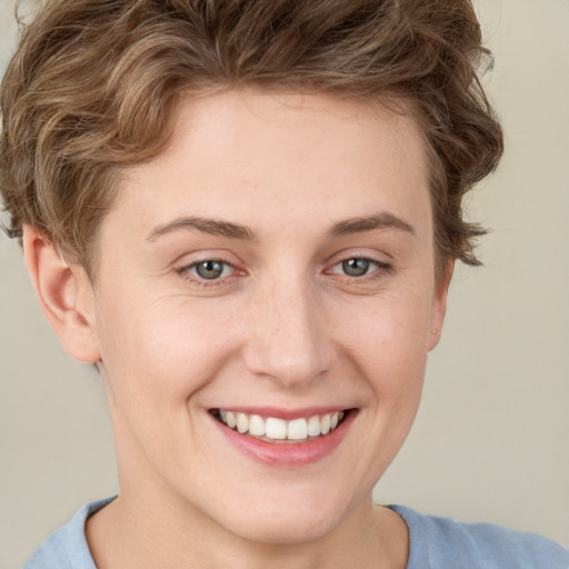 Joyful white young-adult female with short  brown hair and grey eyes