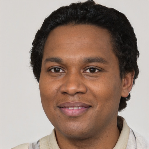 Joyful black young-adult male with short  black hair and brown eyes