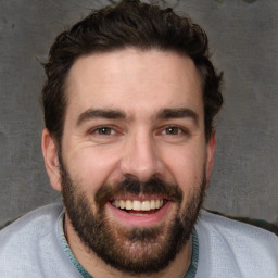 Joyful white young-adult male with short  black hair and brown eyes