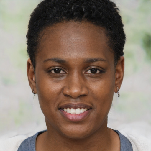 Joyful black young-adult female with short  black hair and brown eyes