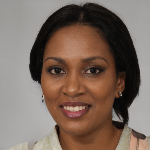 Joyful black adult female with medium  black hair and brown eyes