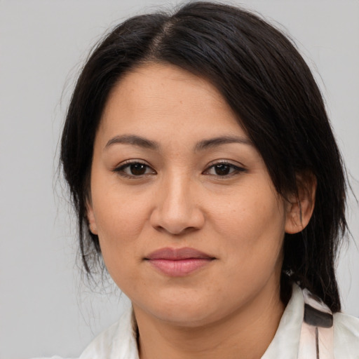 Joyful asian young-adult female with medium  brown hair and brown eyes