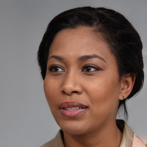 Joyful black young-adult female with medium  black hair and brown eyes