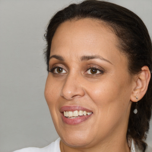 Joyful white adult female with medium  brown hair and brown eyes