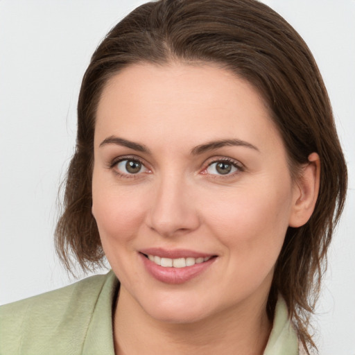 Joyful white young-adult female with medium  brown hair and brown eyes