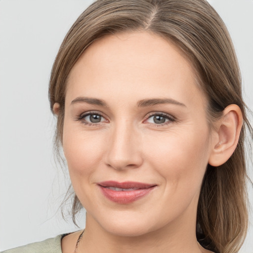 Joyful white young-adult female with long  brown hair and grey eyes