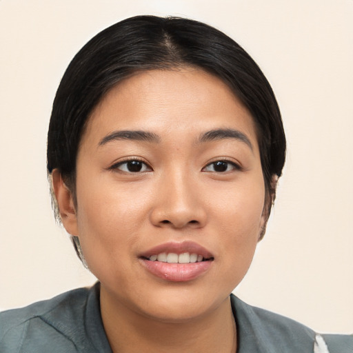 Joyful asian young-adult female with short  black hair and brown eyes