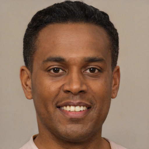 Joyful latino young-adult male with short  brown hair and brown eyes