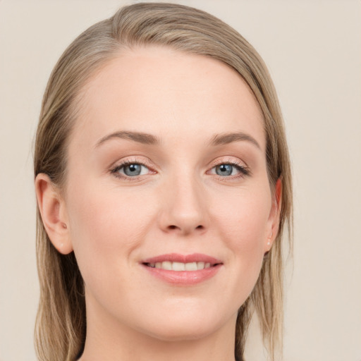 Joyful white young-adult female with long  brown hair and blue eyes