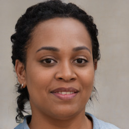 Joyful black young-adult female with medium  brown hair and brown eyes