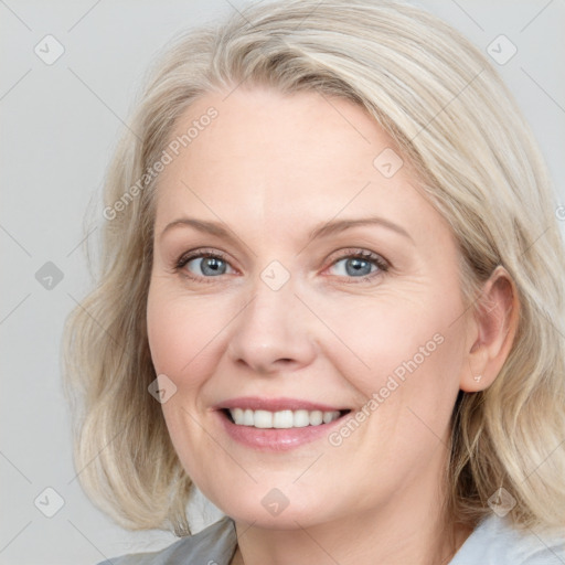 Joyful white adult female with medium  brown hair and blue eyes