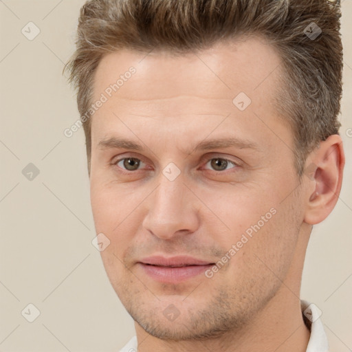 Joyful white adult male with short  brown hair and brown eyes