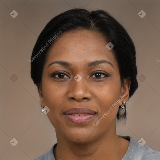 Joyful black adult female with medium  black hair and brown eyes