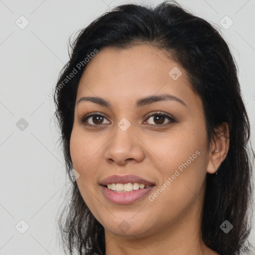 Joyful latino young-adult female with long  brown hair and brown eyes