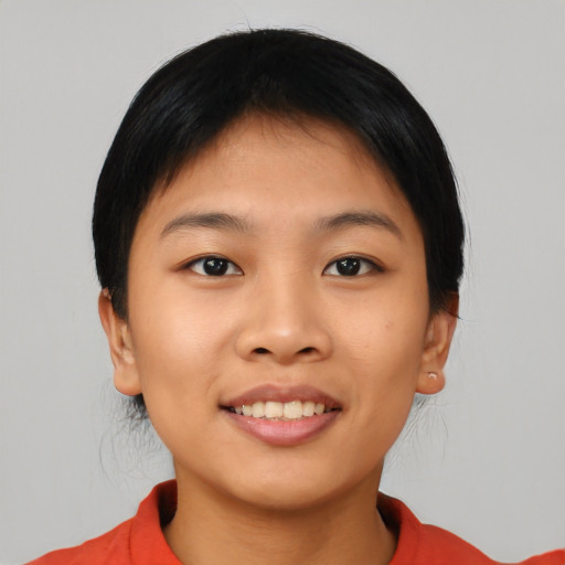 Joyful asian young-adult female with short  black hair and brown eyes