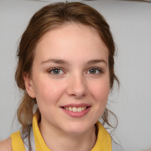 Joyful white young-adult female with medium  brown hair and blue eyes