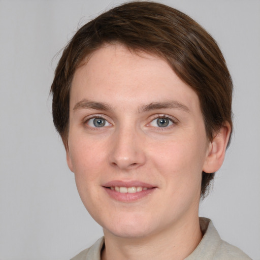 Joyful white young-adult female with short  brown hair and grey eyes