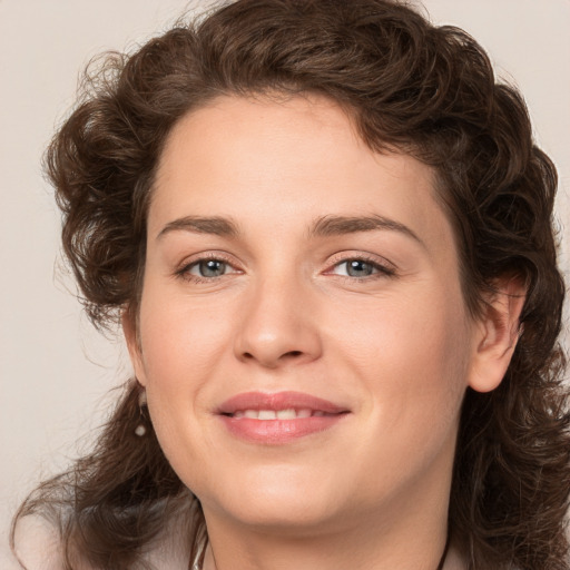 Joyful white young-adult female with medium  brown hair and green eyes