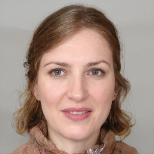 Joyful white young-adult female with medium  brown hair and blue eyes