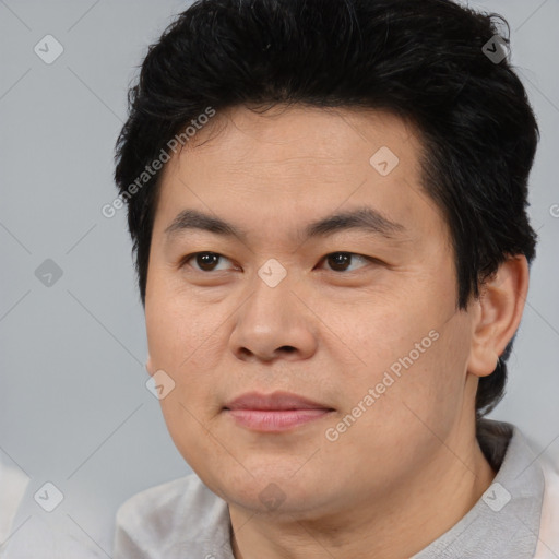 Joyful asian young-adult male with short  black hair and brown eyes