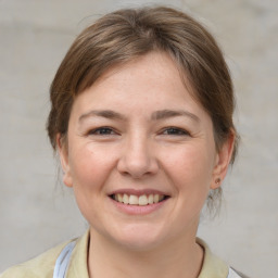 Joyful white young-adult female with medium  brown hair and brown eyes