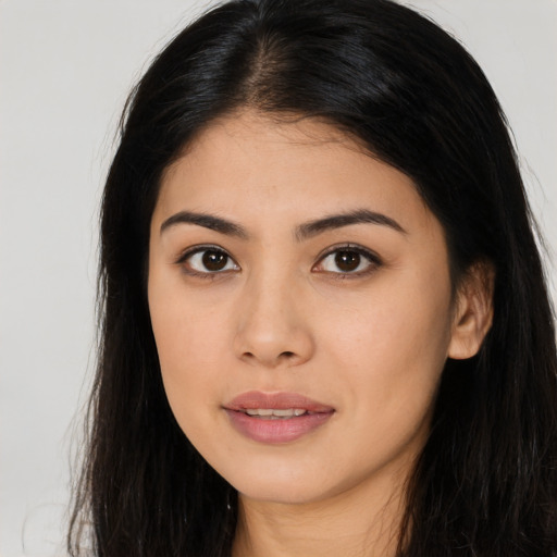 Joyful asian young-adult female with long  brown hair and brown eyes