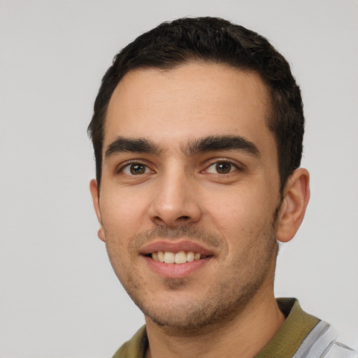 Joyful white young-adult male with short  black hair and brown eyes