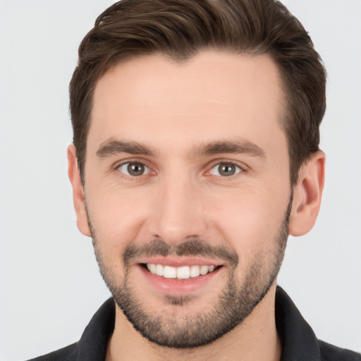 Joyful white young-adult male with short  brown hair and brown eyes