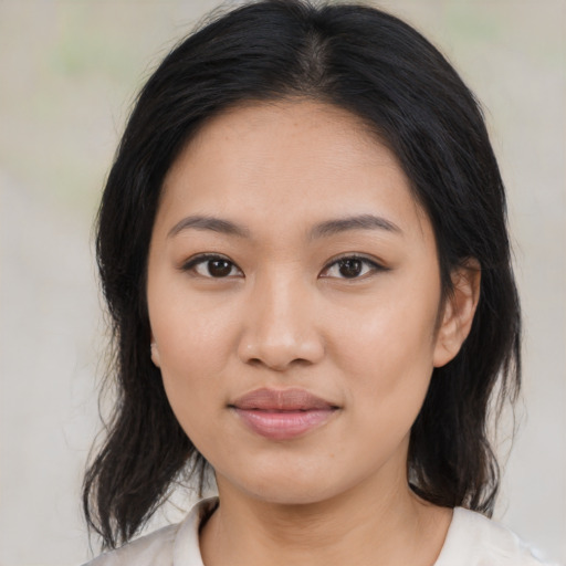 Joyful asian young-adult female with medium  brown hair and brown eyes