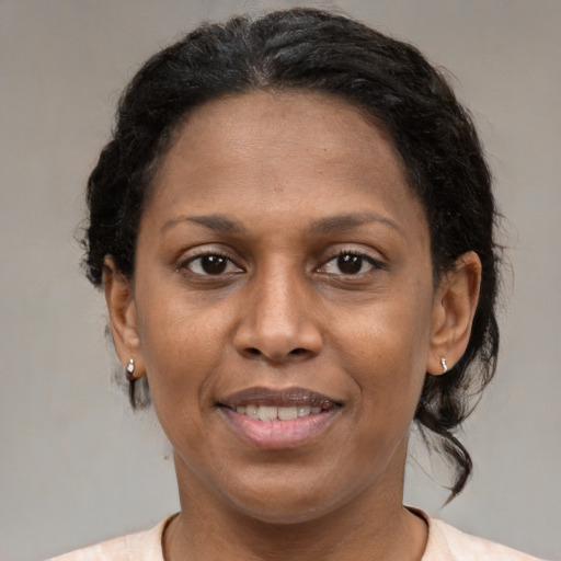 Joyful latino adult female with medium  brown hair and brown eyes