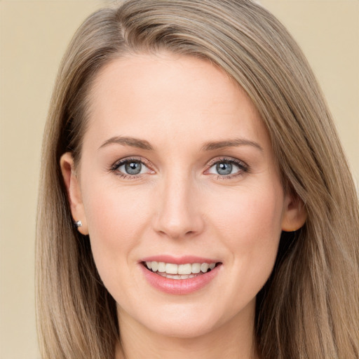 Joyful white young-adult female with long  brown hair and grey eyes