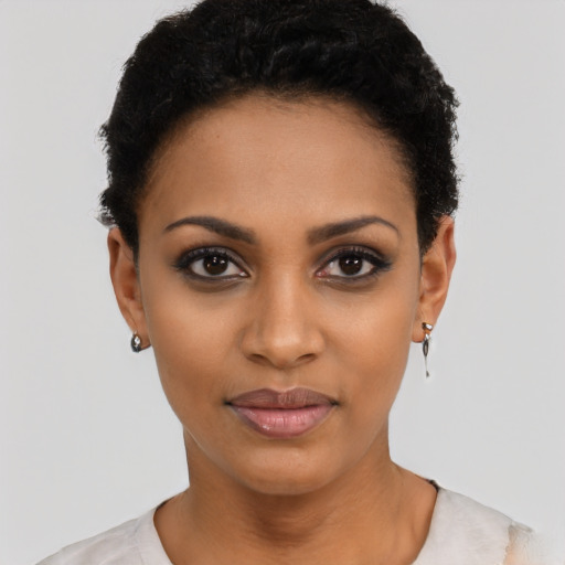Joyful black young-adult female with short  black hair and brown eyes