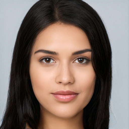 Joyful latino young-adult female with long  brown hair and brown eyes