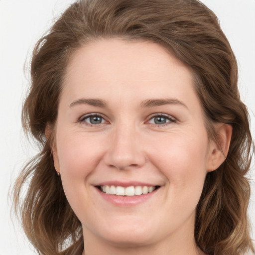 Joyful white young-adult female with long  brown hair and grey eyes