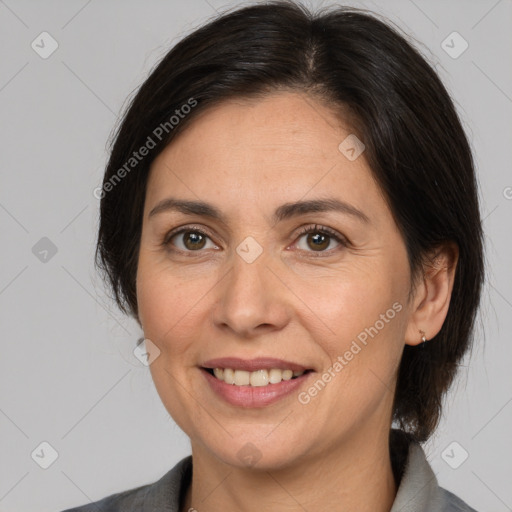 Joyful white adult female with medium  brown hair and brown eyes