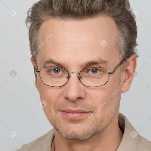 Joyful white adult male with short  brown hair and grey eyes