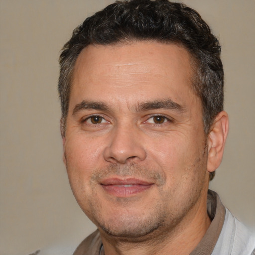 Joyful white adult male with short  brown hair and brown eyes