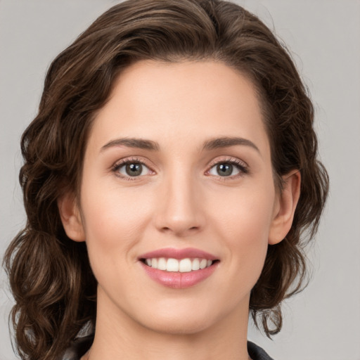 Joyful white young-adult female with medium  brown hair and green eyes