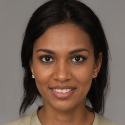 Joyful black young-adult female with medium  brown hair and brown eyes