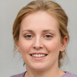 Joyful white young-adult female with medium  brown hair and blue eyes