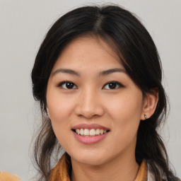 Joyful asian young-adult female with long  brown hair and brown eyes