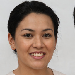 Joyful asian young-adult female with short  brown hair and brown eyes