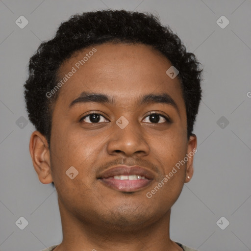 Joyful black young-adult male with short  brown hair and brown eyes
