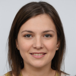 Joyful white young-adult female with medium  brown hair and brown eyes