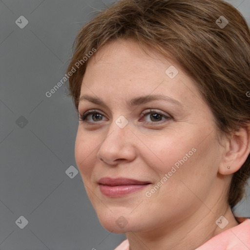 Joyful white adult female with medium  brown hair and brown eyes