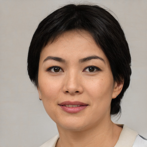Joyful asian young-adult female with medium  black hair and brown eyes