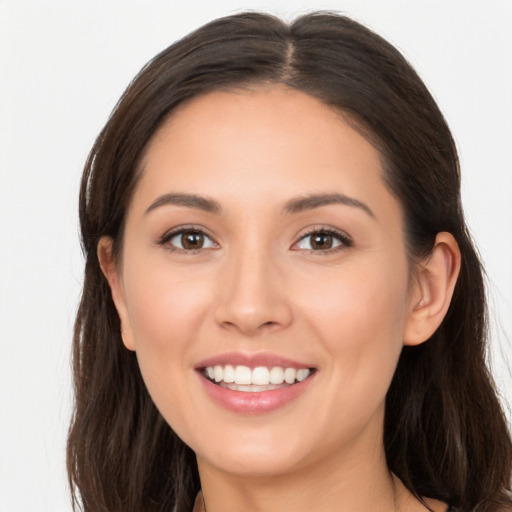 Joyful white young-adult female with long  brown hair and brown eyes