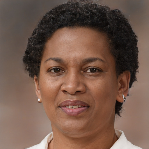 Joyful black adult female with short  brown hair and brown eyes
