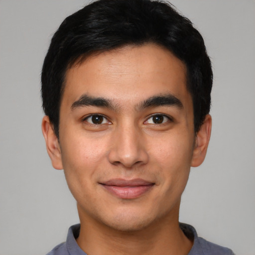 Joyful asian young-adult male with short  black hair and brown eyes